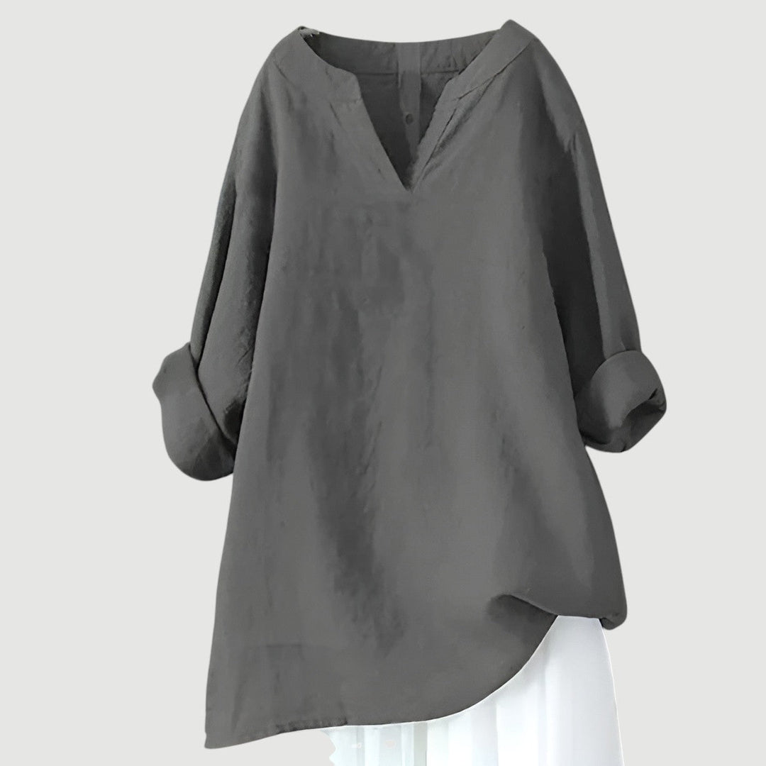 Woman in a classic neckline casual shirt with a plain background.