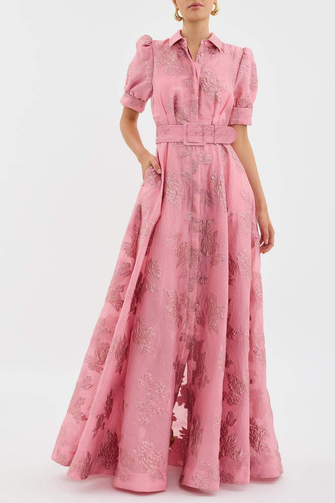 Female wearing a blush pink belted midi dress against a plain background.