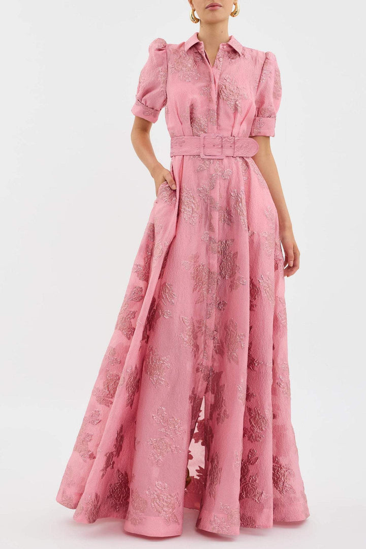 Female wearing a blush pink belted midi dress against a plain background.
