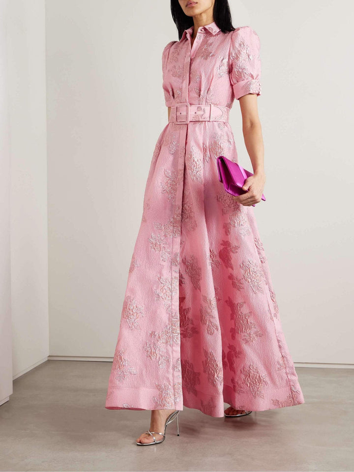 Woman wearing a belted midi dress with a classic feminine silhouette.