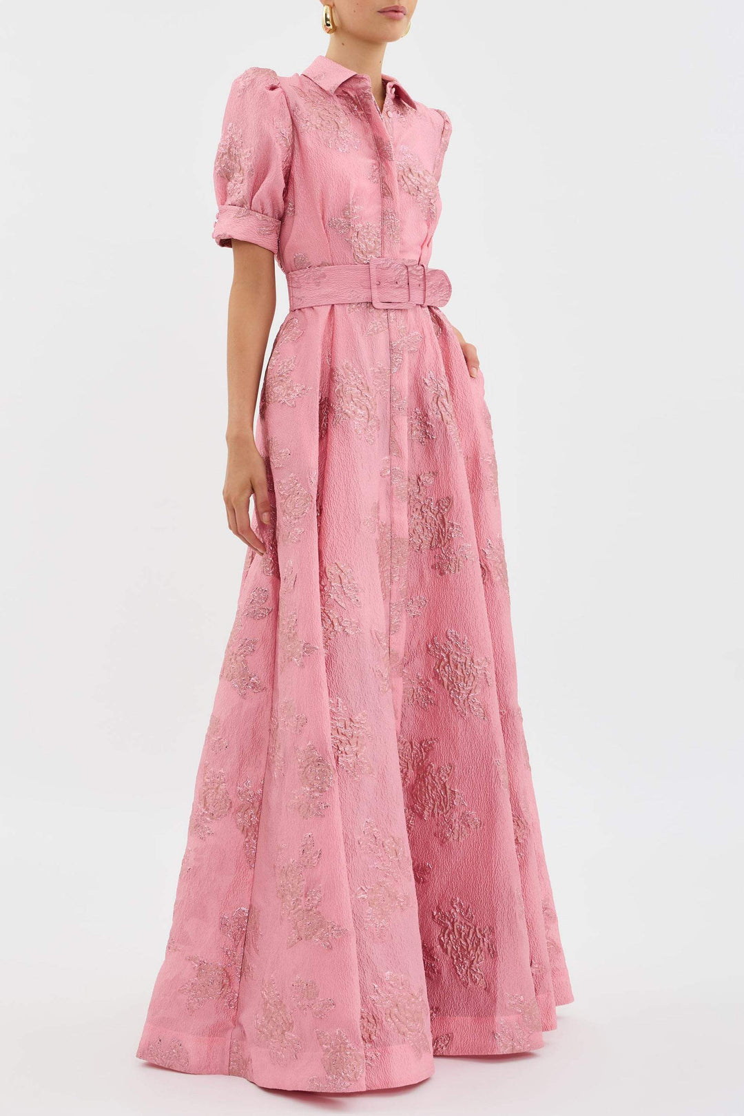 Female in a soft pink dress featuring a flattering belt detail.