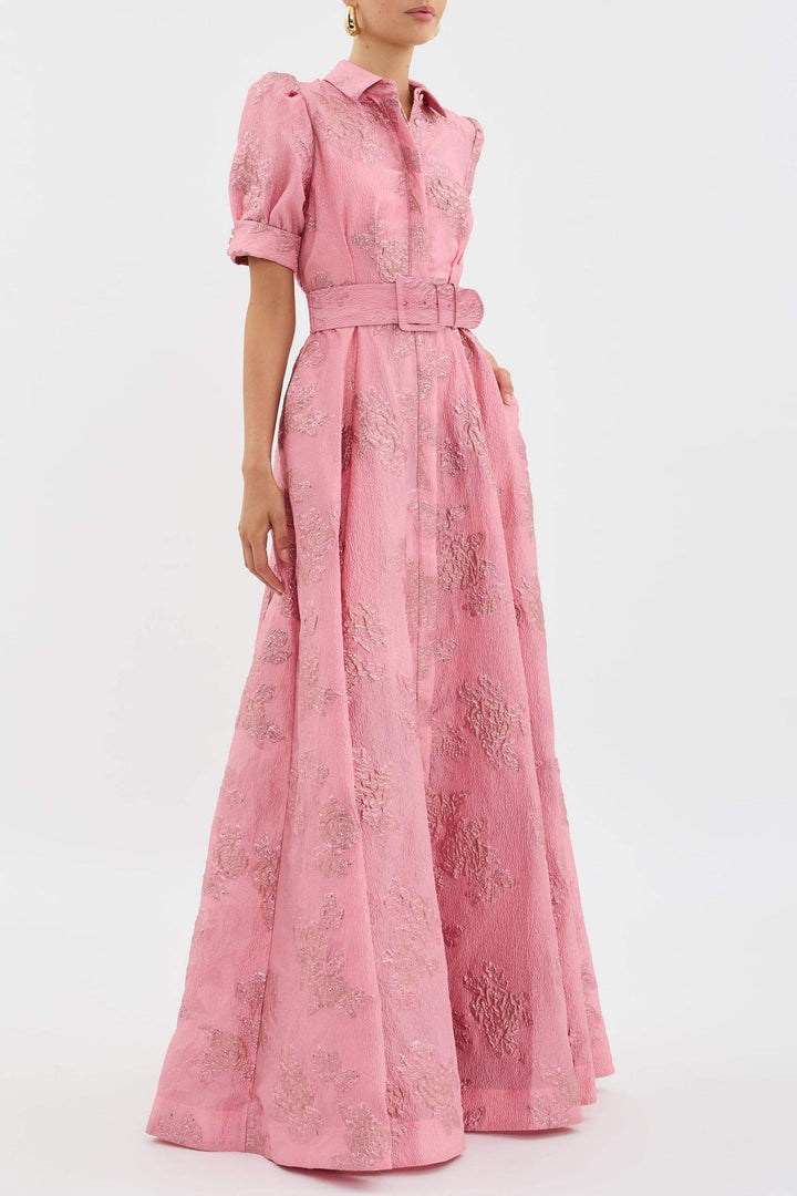 Female in a soft pink dress featuring a flattering belt detail.