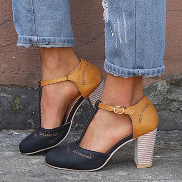 Elegant women’s low heel shoes on a plain background with a refined closed-toe design.