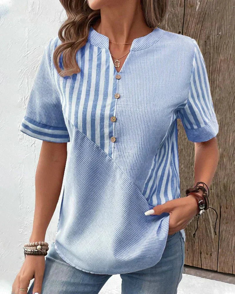 Female in a lightweight blouse featuring a timeless stripe pattern.