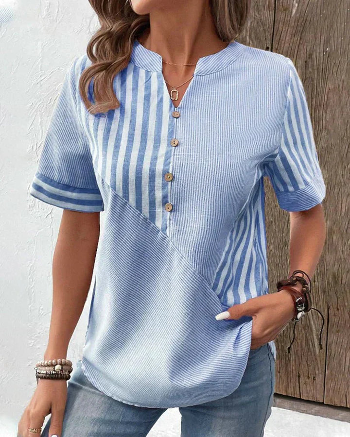 Female in a lightweight blouse featuring a timeless stripe pattern.