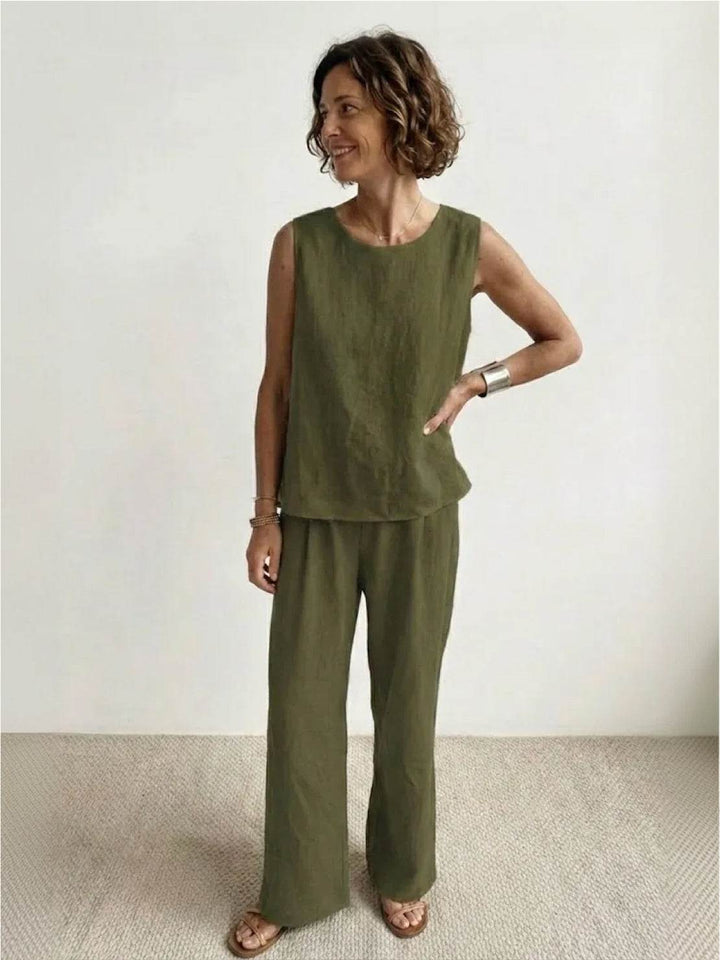Female model wearing a sleeveless two-piece set with a tank top and wide-leg trousers against a plain background.
