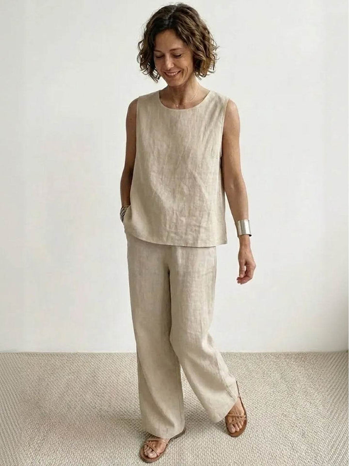  Female model showcasing a sleeveless top and wide-leg trouser set with a clean silhouette.