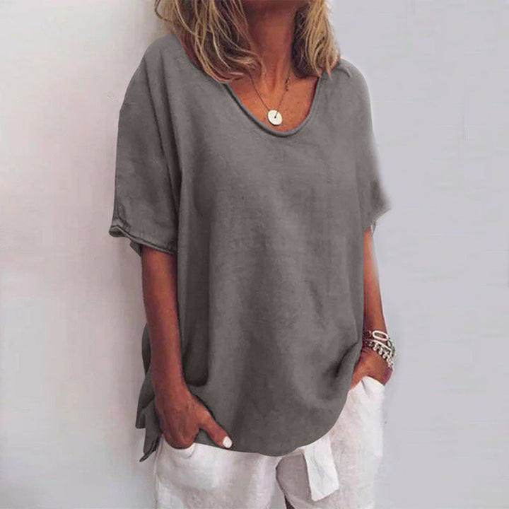  Woman modelling a draped blouse with an easy-going silhouette.