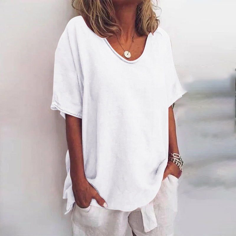  Female modelling a lightweight blouse with a flowing shape on a plain background.