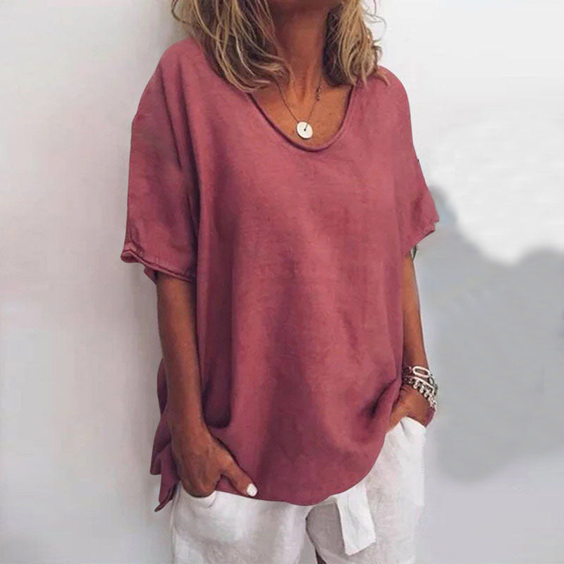 
Female in a lightweight blouse with a relaxed shape against a plain background.