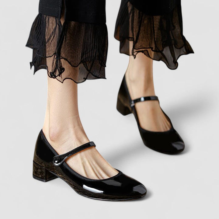 Classic women’s shoes on a plain background with a refined rounded shape.