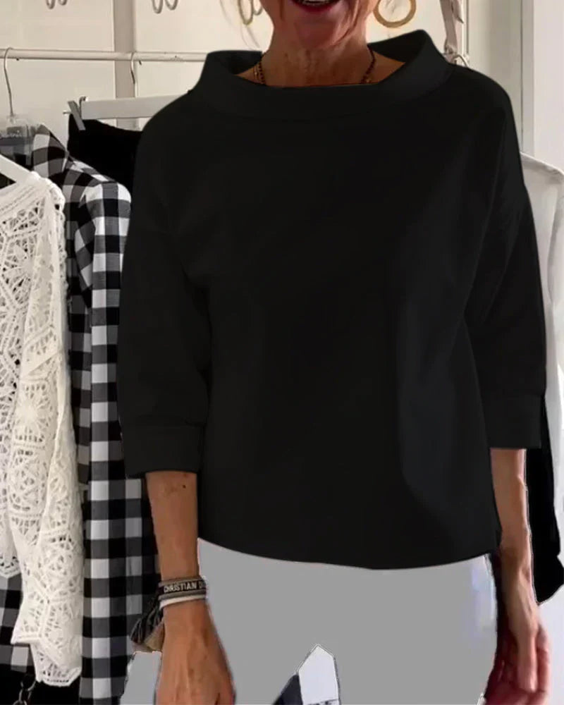 Woman modelling a versatile casual top with rolled neckline detail.
