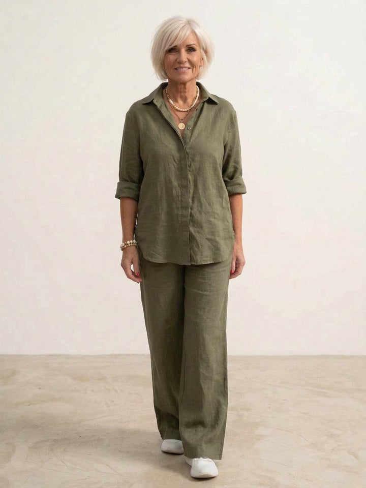Female model wearing a coordinated shirt and wide-leg trouser set on a plain background.