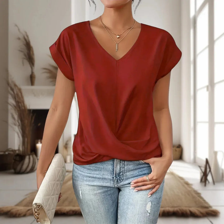  Female wearing a lightweight casual top with a feminine neckline.