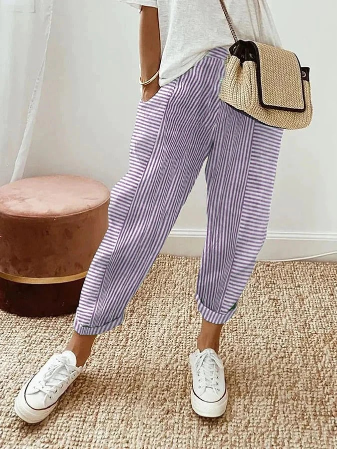 Woman in high-waisted striped trousers designed for casual and smart occasions.