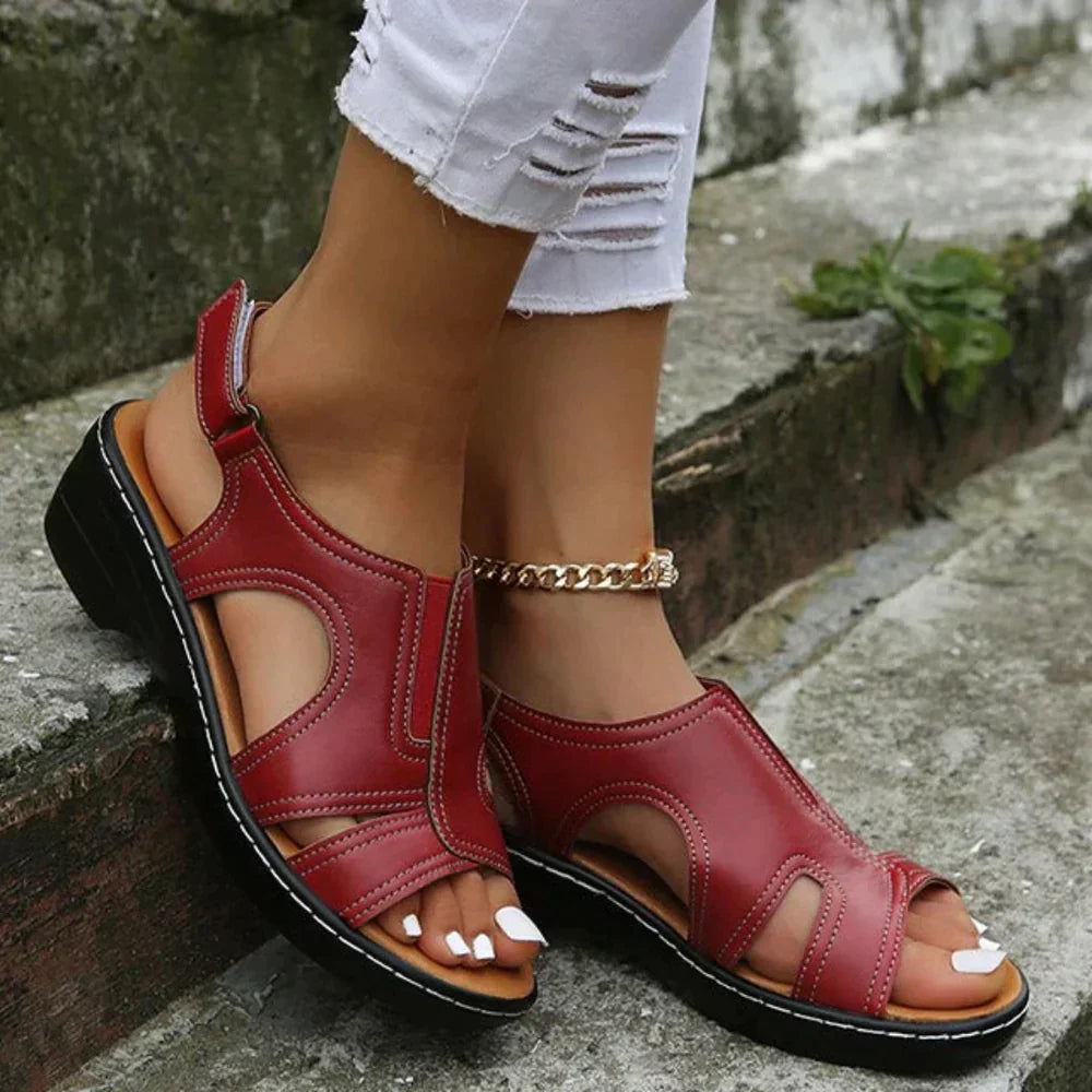 Female model showing adjustable strap sandals against a plain background.