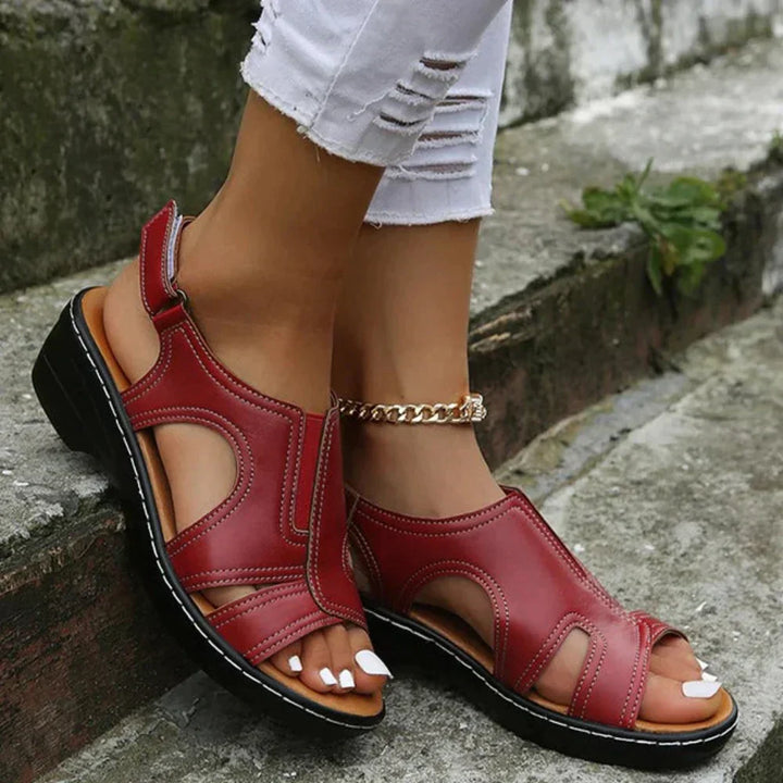 Female model showing adjustable strap sandals against a plain background.