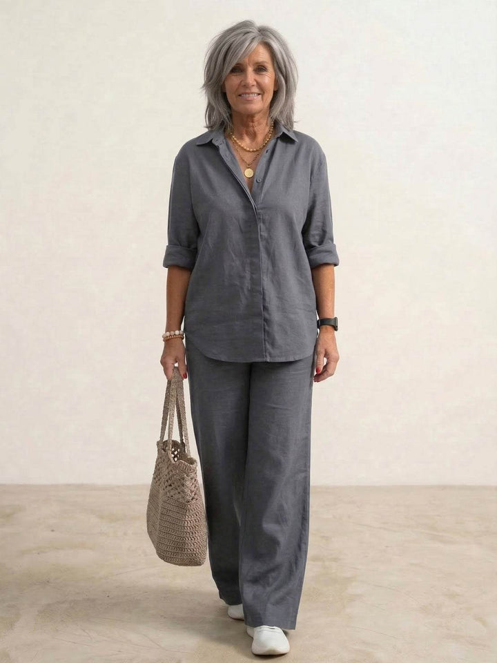 Female model styled in a coordinated outfit featuring wide-leg trousers and a relaxed shirt.