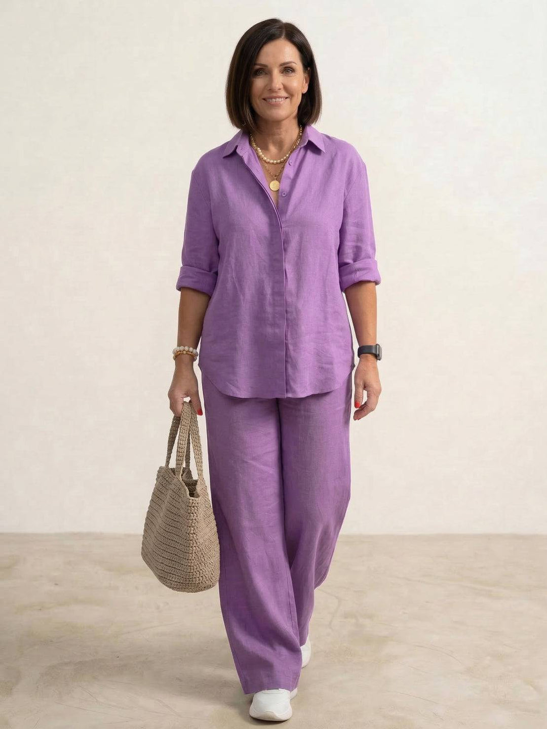 Female model wearing a two-piece summer outfit with an oversized shirt and wide-leg trousers.