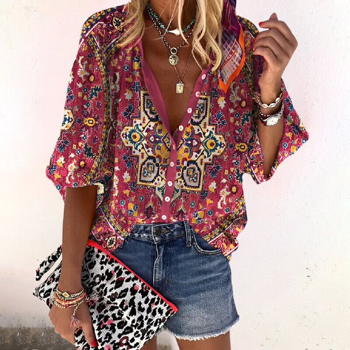  Woman wearing a relaxed fit printed blouse with long sleeves.