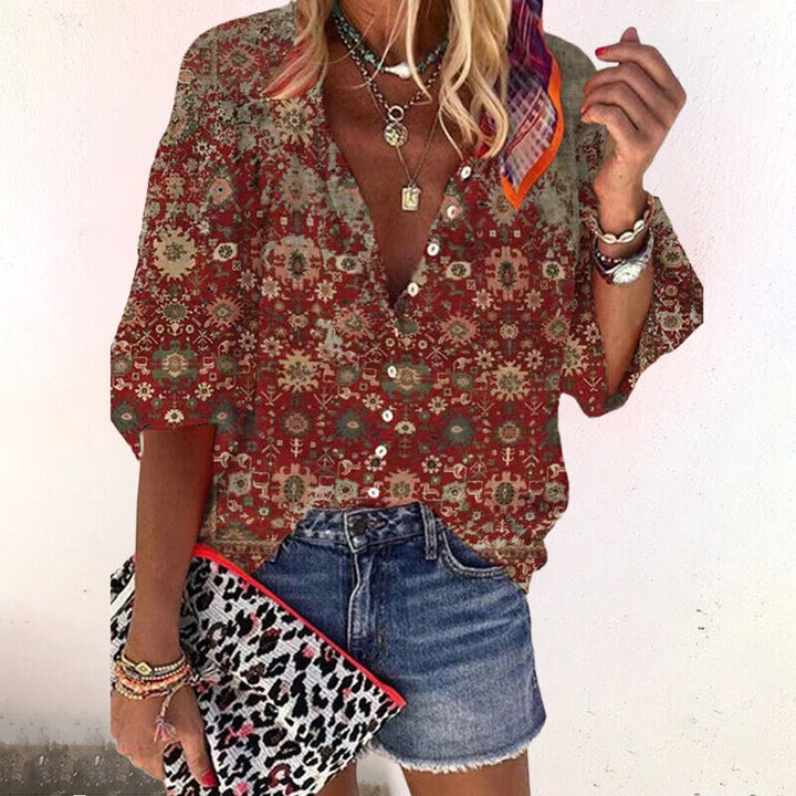  Female in a V-neck blouse featuring an intricate patterned design.