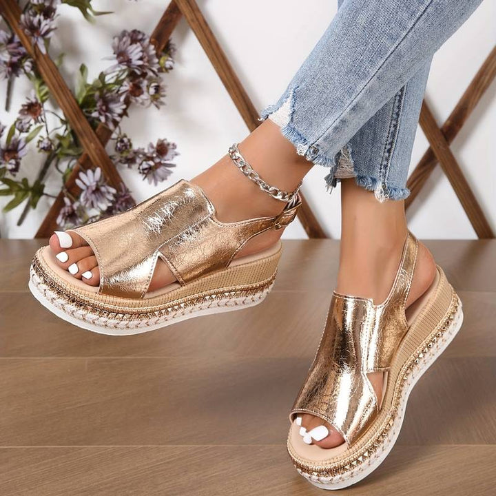  Female model showcasing open-toe sandals with a subtle lift and star detail.