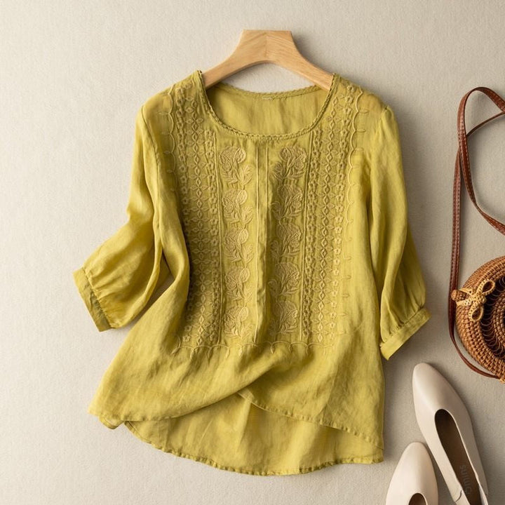 A casual blouse with intricate embroidered accents.