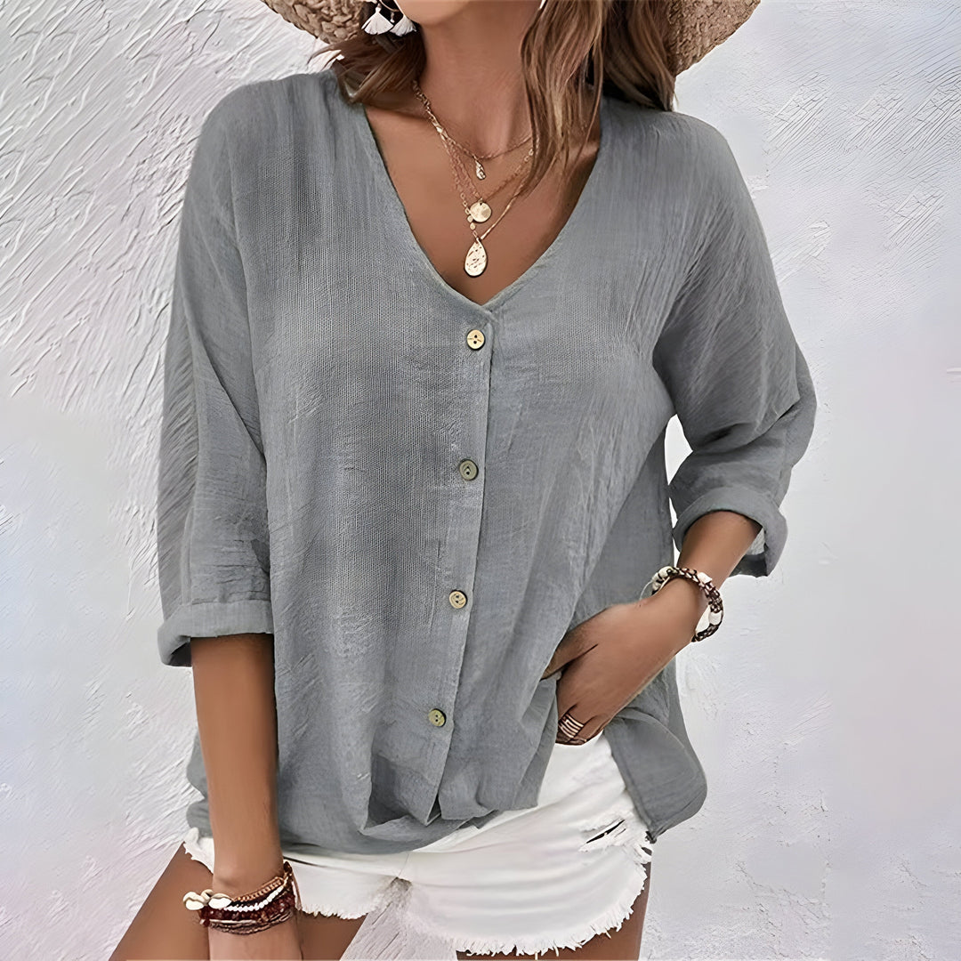 
Woman wearing a V-neck blouse styled for casual and smart-casual occasions.