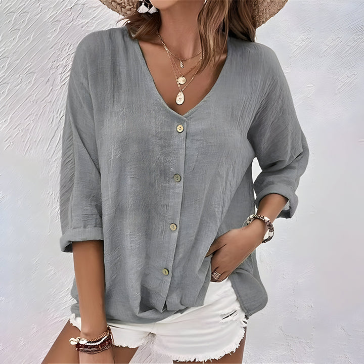 
Woman wearing a V-neck blouse styled for casual and smart-casual occasions.