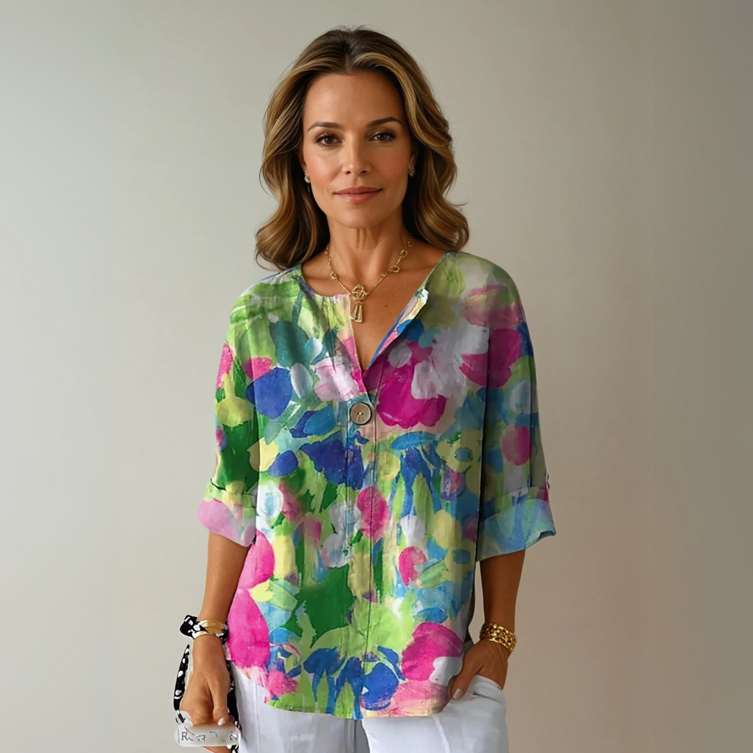  Female wearing a patterned blouse with a flattering silhouette.