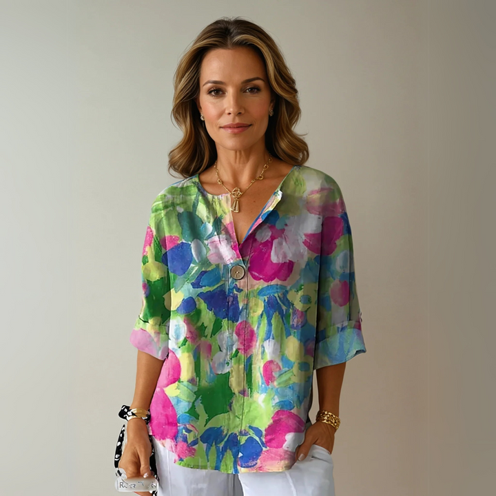  Female wearing a patterned blouse with a flattering silhouette.