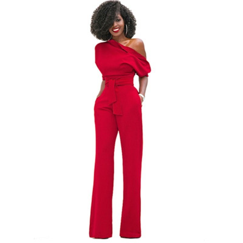 Female model in a sleeveless one-shoulder jumpsuit on a plain background.