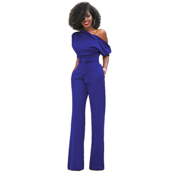 Model wearing an asymmetrical wide-leg jumpsuit against a plain background.