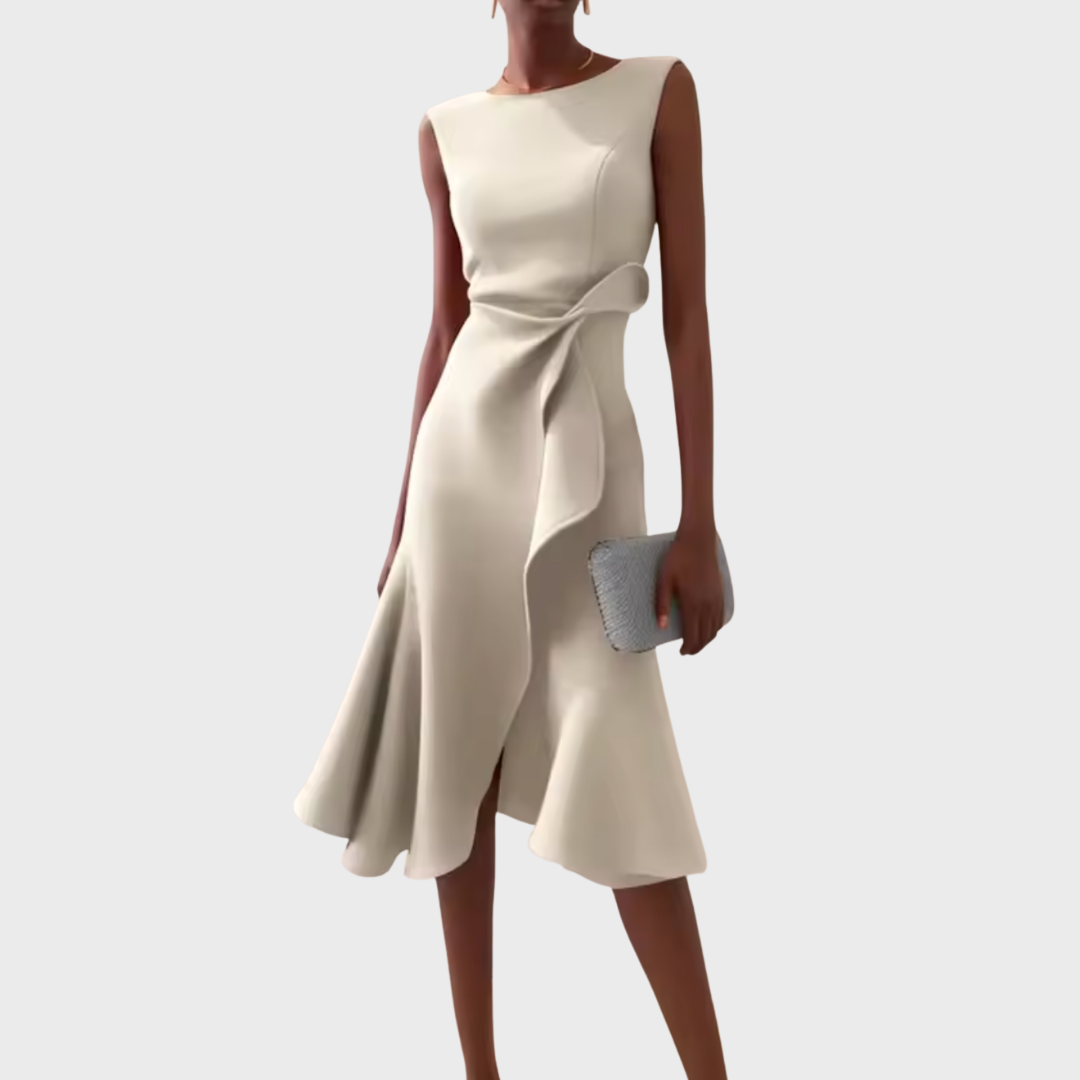 Woman in a printed midi dress with a flowy A-line silhouette on a plain background.