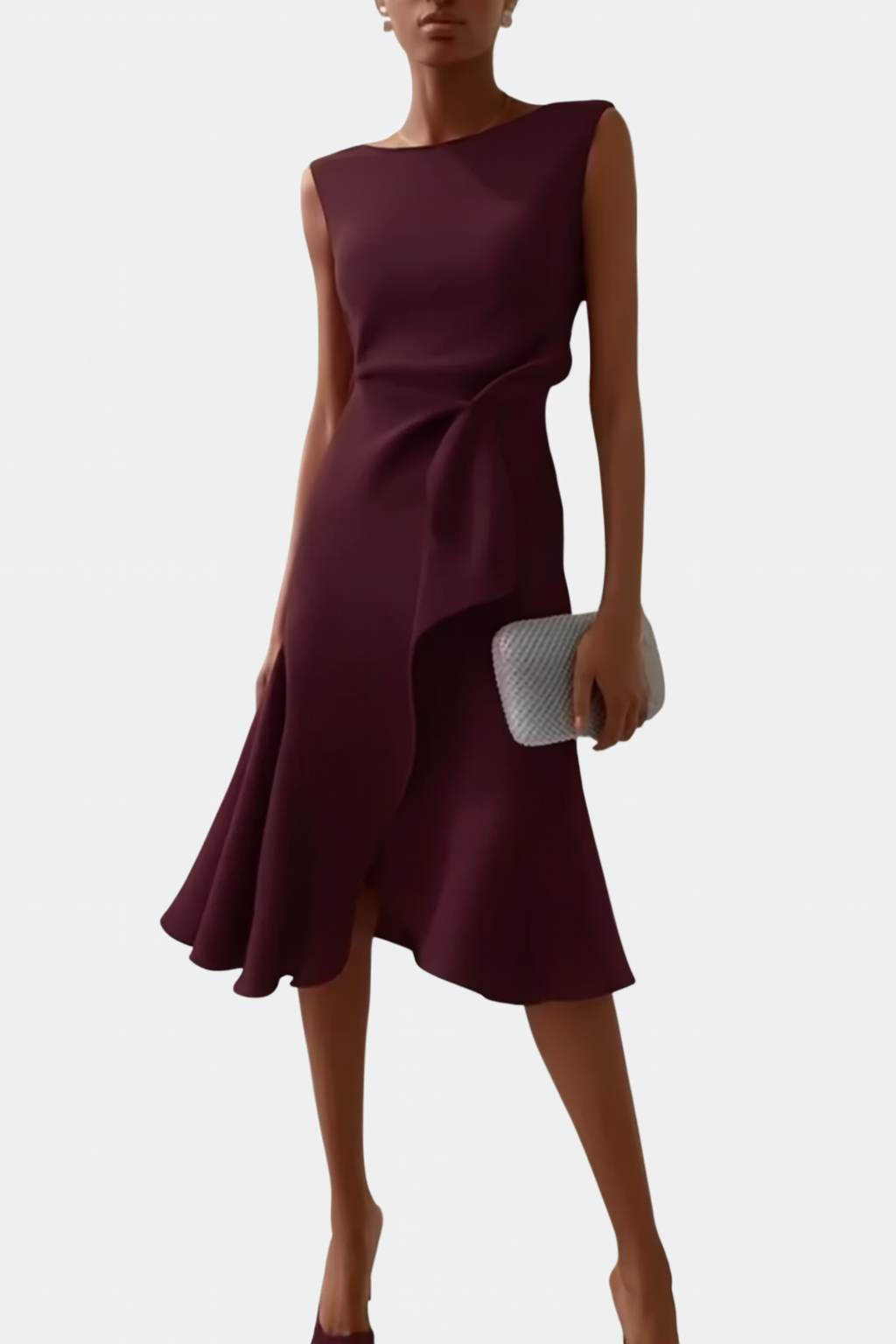 Woman wearing a midi-length printed dress for daily styling on a plain background.