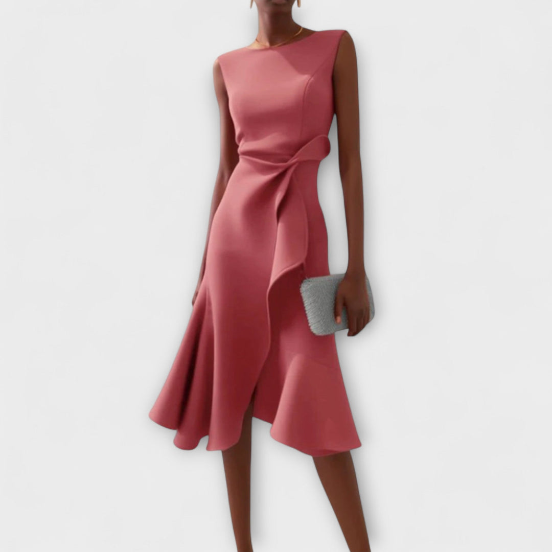 Female model showcasing an A-line printed midi dress with pockets on a plain background.
