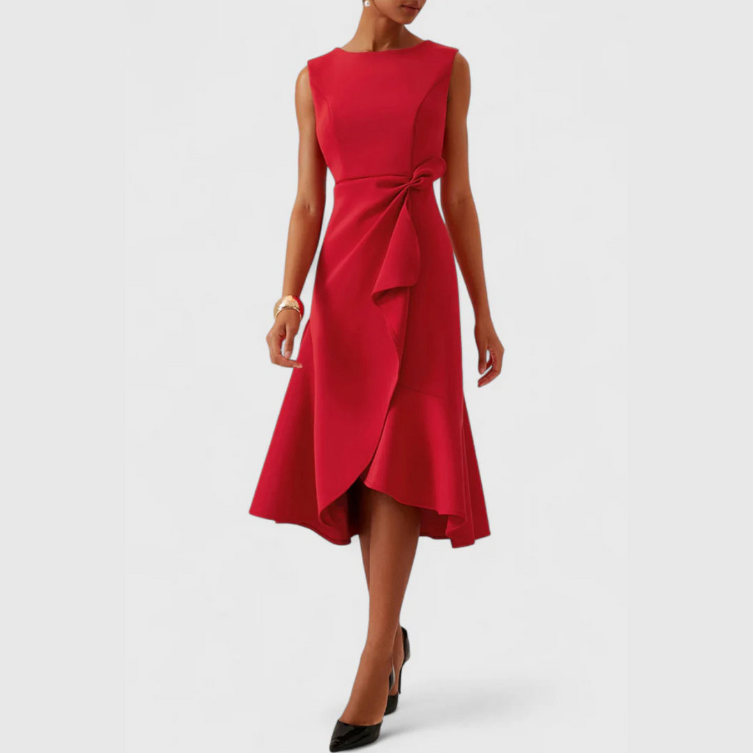 Woman displaying a relaxed A-line printed midi dress on a plain background.