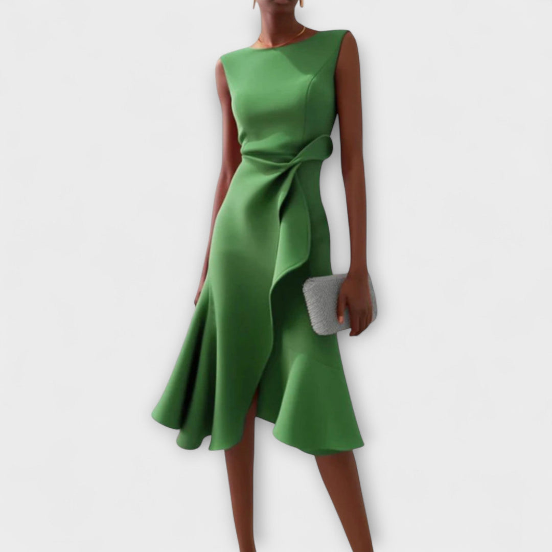 Woman wearing a printed midi dress on a plain background.