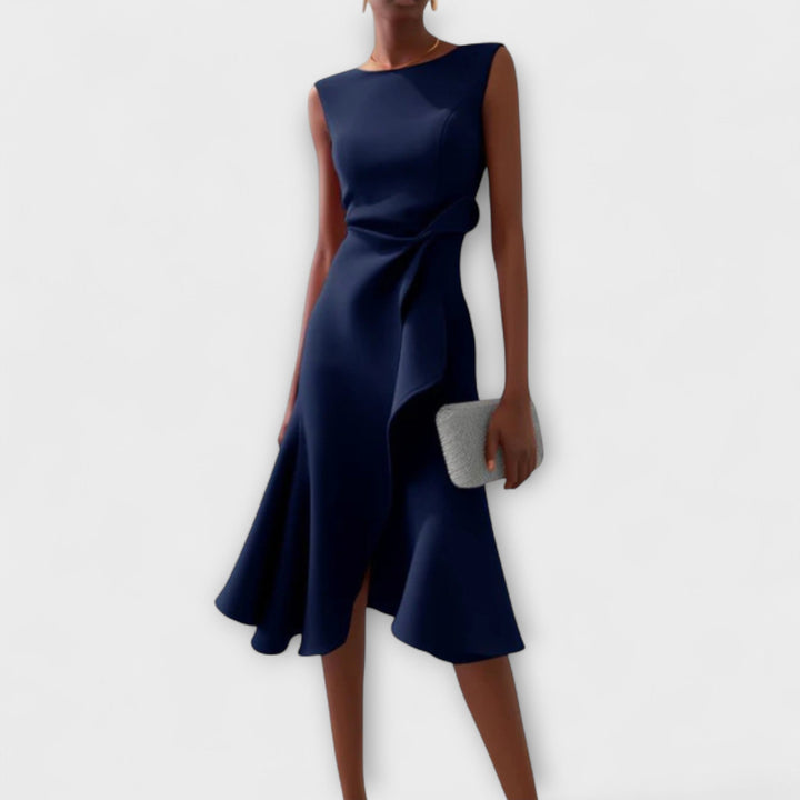 Woman in a relaxed fit printed midi dress with midi length displayed on a plain background.