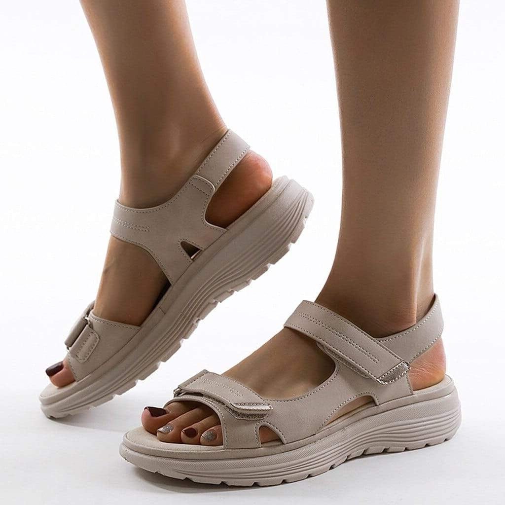 Female model wearing lightweight casual sandals on a plain background.