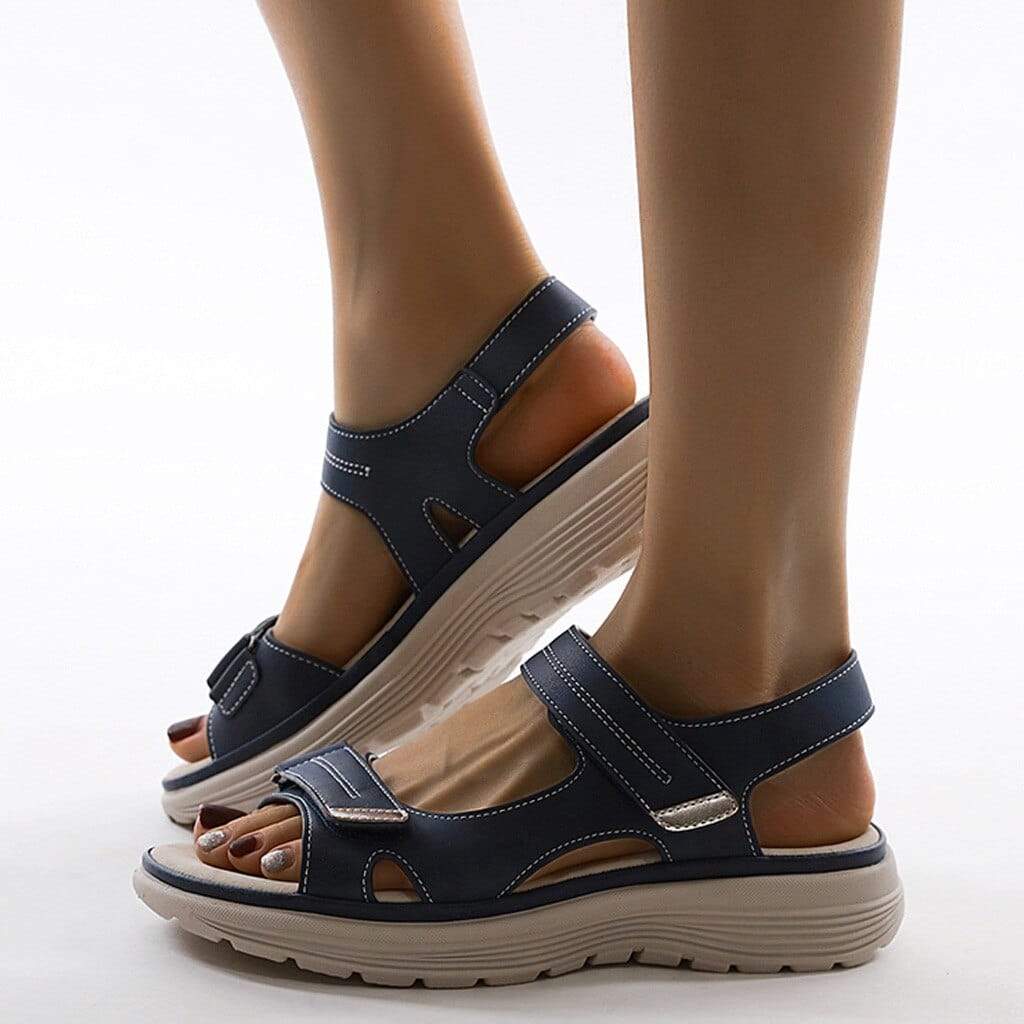 Model showing summer walking sandals with dual straps on a plain background.