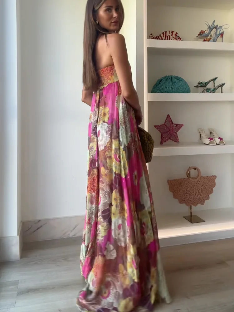  Female model in a strapless dress featuring an all-over floral print on a plain background.