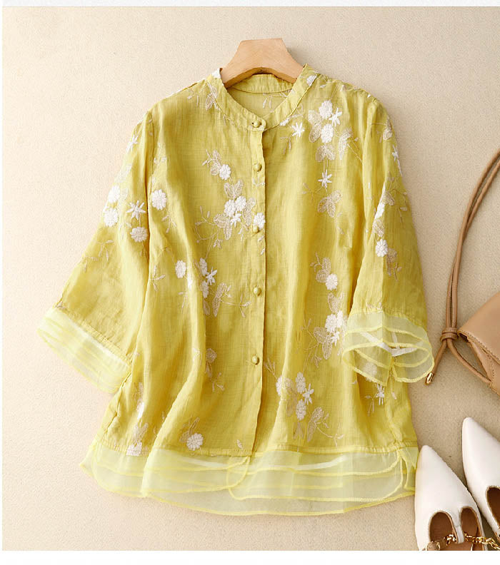 A relaxed fit embroidered blouse on a plain background.
